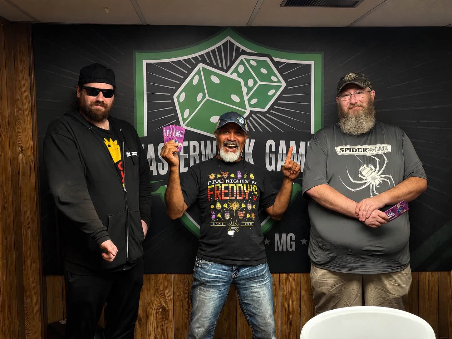 Three local players posing together at Masterwork Gaming