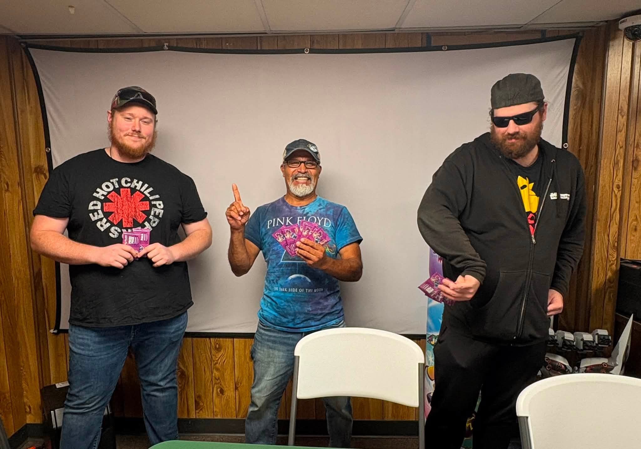 A group of players holding cards at the shop