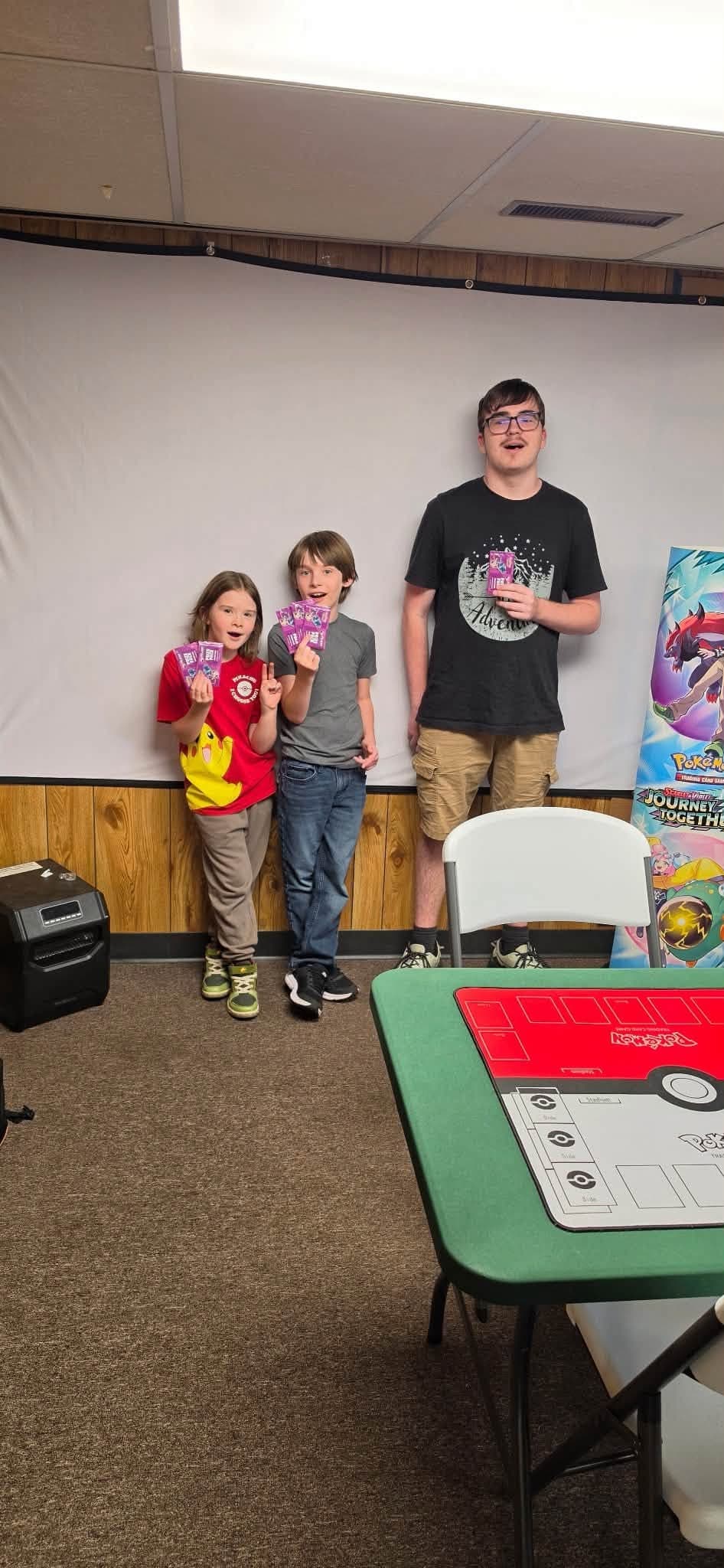 Young players showing their cards after a shop session